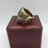 Side view of the 1981 Cincinnati Bengals AFC Championship Ring Replica placed on a wooden box, featuring detailed engraving of “Super Bowl XVI” and team graphics in a gold-tone Zinc Alloy design
