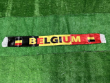 Belgium scarf with national flag design on a green grass background