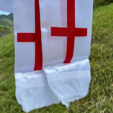 Close up White fabric England Scarf with red crosses on a grassy background