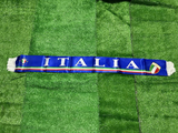 Italian flag-themed scarf on a green grass background