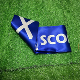 SCOTLAND Scarf  with white cross and 'SCOTLAND' on green grass