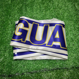 Uruguay Scarf with 'URUGUAY' printed on it, lying on a green grass surface.