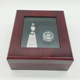 Wooden box with a glass lid containing a Philadelphia Eagles championship ring 2017 and trophy replica.