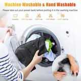 Person washing a black heated jacket in a washing machine with washing instructions displayed.